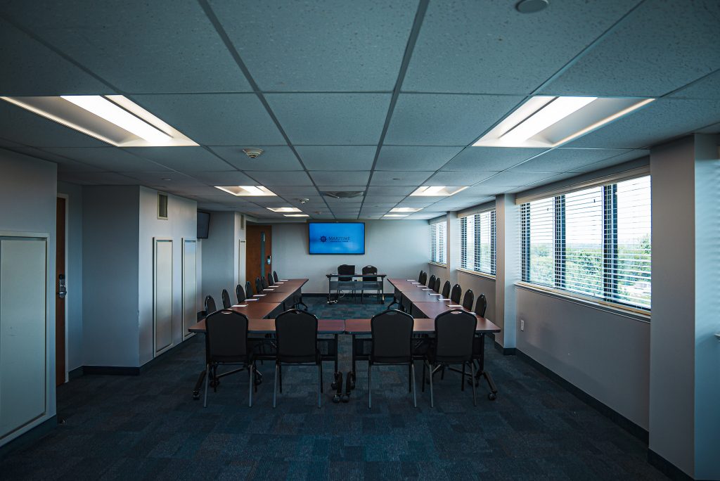 Maritime conference center meeting room space with a U-shaped table and chairs